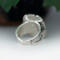 back view, cushion black onyx gemstone bezel set bead wire and stamped cutout wire accent on tapered wide band